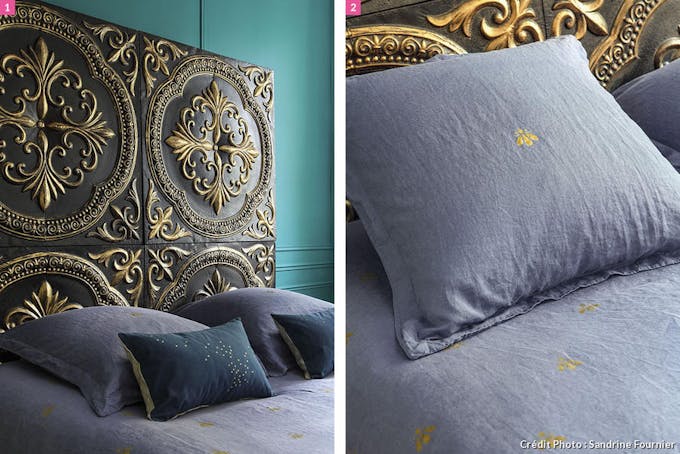 Tête de lit avec dorures, motifs inspiré de la royauté comme le Lys. Oreillers.