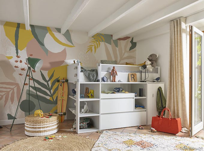 une chambre d'enfant avec un papier peint jungle coloré