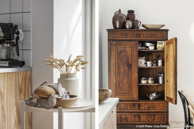 L'armoire en bois achetée à une vente aux enchères est remplie de vaisselle et d'épicerie, un rangement supplémentaire parfait pour la cuisine.